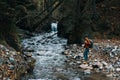 woman tourist photographing nature river forest mountains Royalty Free Stock Photo