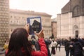 Woman tourist photographs basilica San Petronio in Bologna city on tablet in Italy. Travel concep. Bologna, Italy