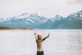 Woman tourist raised hands enjoying mountains and fjord view Royalty Free Stock Photo