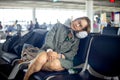 Tourist wait for flight and feel tired sleep on the chair