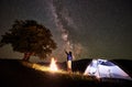 Woman tourist resting at night camping under starry sky and Milky way