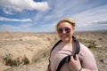 Woman tourist 20s poses at the Borrego Badlands overlook in Anza Borrego Desert State Park in CA