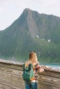 Woman tourist sightseeing looking at view in Norway solo travel backpacking