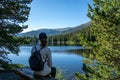 woman sitting at bear lake in spring summer in the rocky mountain national park, colorado united states of america Royalty Free Stock Photo