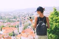 Woman with smartphone in hand on background of Ljubljana City, S