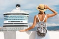 Woman tourist standing in front of big cruise liner, travel female