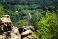 Woman tourist stands on rock top in resort park, Kislovodsk, Russia