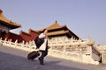 A woman tourist with suitcase at Forbidden City, China