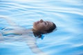 Woman tourist swimming in infinity pool Royalty Free Stock Photo