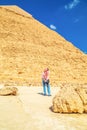 Woman tourist takes photographs of the Pyramid of Khafre