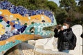 Woman, tourist, takes photos in the park Guell, Barcelona