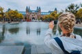 Woman tourist taking photo of the Rijksmuseum in Amsterdam on the mobile phone. Travel in Europe city trip concept