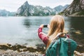 Woman tourist taking selfie by smartphone sightseeing Lofoten islands Royalty Free Stock Photo