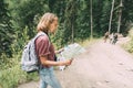 A woman on a tourist trail with a backpack holds a map. Royalty Free Stock Photo