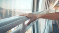 Woman tourist travel in the city by public city sky train system. Woman holding the hand rail in the train close up with Royalty Free Stock Photo