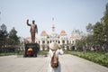 Woman tourist is traveling and sightseeing at Hochiminh people`s committee hall landmark of Saigon Royalty Free Stock Photo