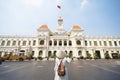 Woman tourist is traveling and sightseeing at Hochiminh people`s committee hall landmark of Saigon Royalty Free Stock Photo