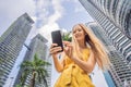 Woman Tourist using navigation app on the mobile phone. Navigation map on a smartphone in a big city Royalty Free Stock Photo