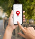 Woman tourist using navigation app on smartphone with red pinpoint on screen Royalty Free Stock Photo