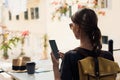 Woman tourist using smartphone at cafe. Travel, enjoying life, technology, staying connected, communication online concept