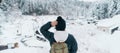 Woman tourist Visiting Ginzan Onsen in Yamagata, happy Traveler sightseeing Japanese Onsen village with Snow in winter season.