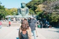 Woman tourist Visiting in Kamakura, Kanagawa, Japan. happy Traveler sightseeing the Great Buddha statue. Landmark and popular for