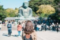 Woman tourist Visiting in Kamakura, Kanagawa, Japan. happy Traveler sightseeing the Great Buddha statue. Landmark and popular for