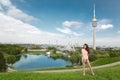 Woman tourist visiting landmark Olympiapark with Olympic tower a