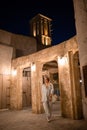 Woman tourist walking in Al Seef Meraas Dubai - old historical district with traditional Arabic architecture Royalty Free Stock Photo