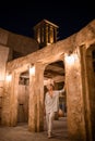 Woman tourist walking in Al Seef Meraas Dubai - old historical district with traditional Arabic architecture Royalty Free Stock Photo