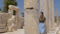 Tourist walking in colonnaded street in Patara, Turkey