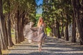 Woman tourist walking in Montenegro. Panoramic summer landscape of the beautiful green Royal park Milocer on the shore Royalty Free Stock Photo