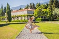 Woman tourist walking in Montenegro. Panoramic summer landscape of the beautiful green Royal park Milocer on the shore Royalty Free Stock Photo