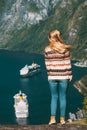 Woman tourist walking over Geiranger fjord in Norway