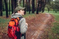 Woman tourist walking in spring forest. Close up of shoes. Traveling and tourism concept