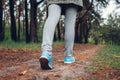 Woman tourist walking in spring forest. Close up of shoes. Traveling and tourism concept