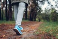 Woman tourist walking in spring forest. Close up of shoes. Traveling and tourism concept