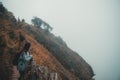 A woman tourist walking and trekking along the mountains in tropical forest