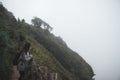 A woman tourist walking and trekking along the mountains in tropical forest