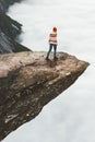 Woman tourist walking on Trolltunga rocky cliff Royalty Free Stock Photo