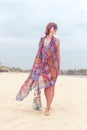 Woman tourist walking on a tropical summer vacation beach wearing sunglasses and beach bag relaxing on travel holidays Royalty Free Stock Photo