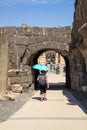 Woman tourist walking with umbrella to protect from heat at Beit She`an, Israel Royalty Free Stock Photo