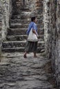 Woman tourist in the walls of the old fortress. Antiquity and the Middle Ages. Vertical