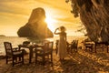 Woman tourist in white dress dinner in restaurant cave on Phra nang Beach at sunset, Railay, Krabi, Thailand. vacation, travel,