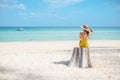 Woman tourist in yellow swimsuit and hat, solo traveller looking beautiful sea view at bamboo island on Phi Phi don island, Krabi Royalty Free Stock Photo