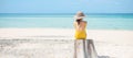 Woman tourist in yellow swimsuit and hat, solo traveller looking beautiful sea view at bamboo island on Phi Phi don island, Krabi Royalty Free Stock Photo