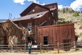 Woman tourists explores the old mining ghost town of Bayhorse Idaho in the Salmon-Challis National Forest