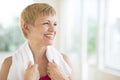 Woman With Towel Around Neck Laughing At Gym Royalty Free Stock Photo