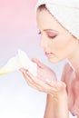 Woman with towel gently holding flower Royalty Free Stock Photo