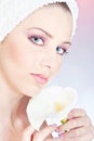 Woman with towel gently holding flower Royalty Free Stock Photo